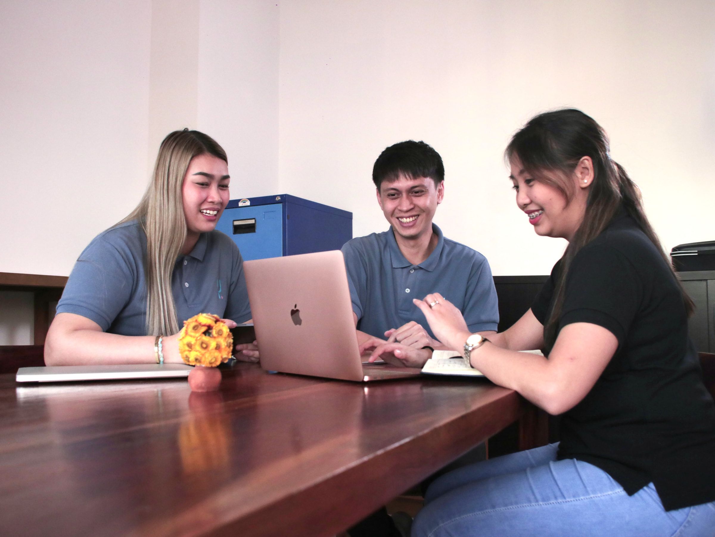 Yoonet teammates collaborating at a dual-monitor workstation in the Balanga office