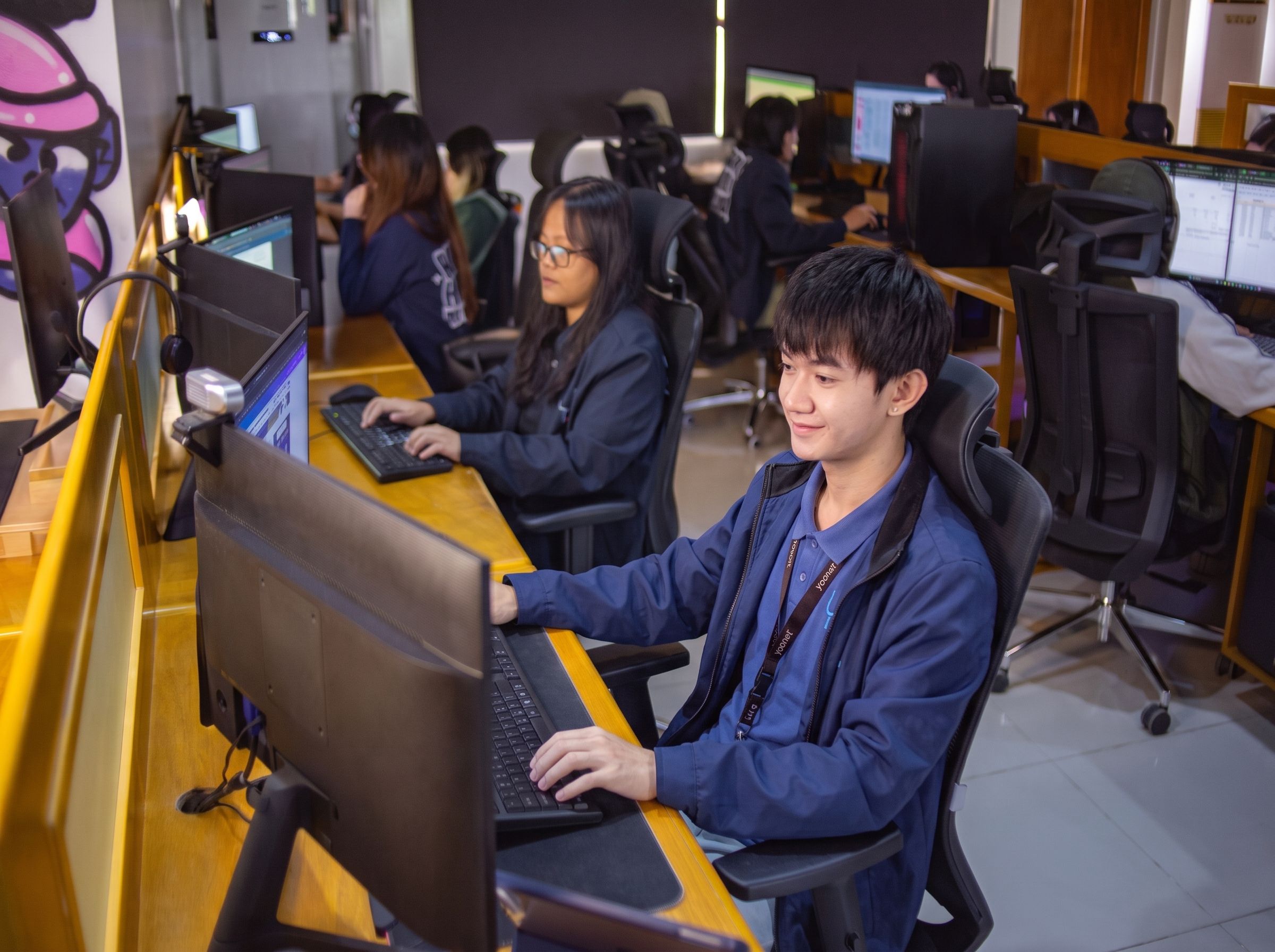 Yoonet teammates working at their monitors in the Balanga office