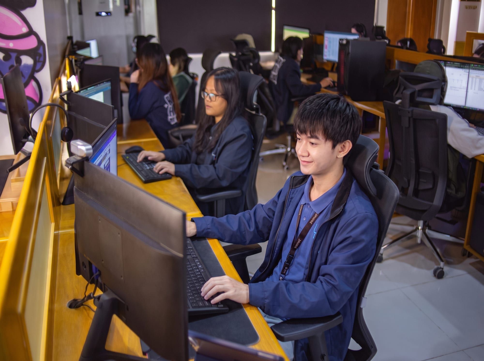 Yoonet teammates working at their monitors in the Balanga office