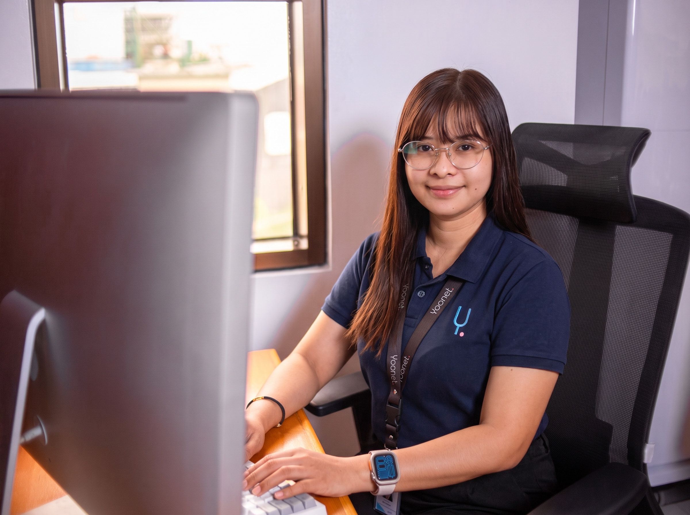 Yoonet teammate at her workstation in the Balanga office