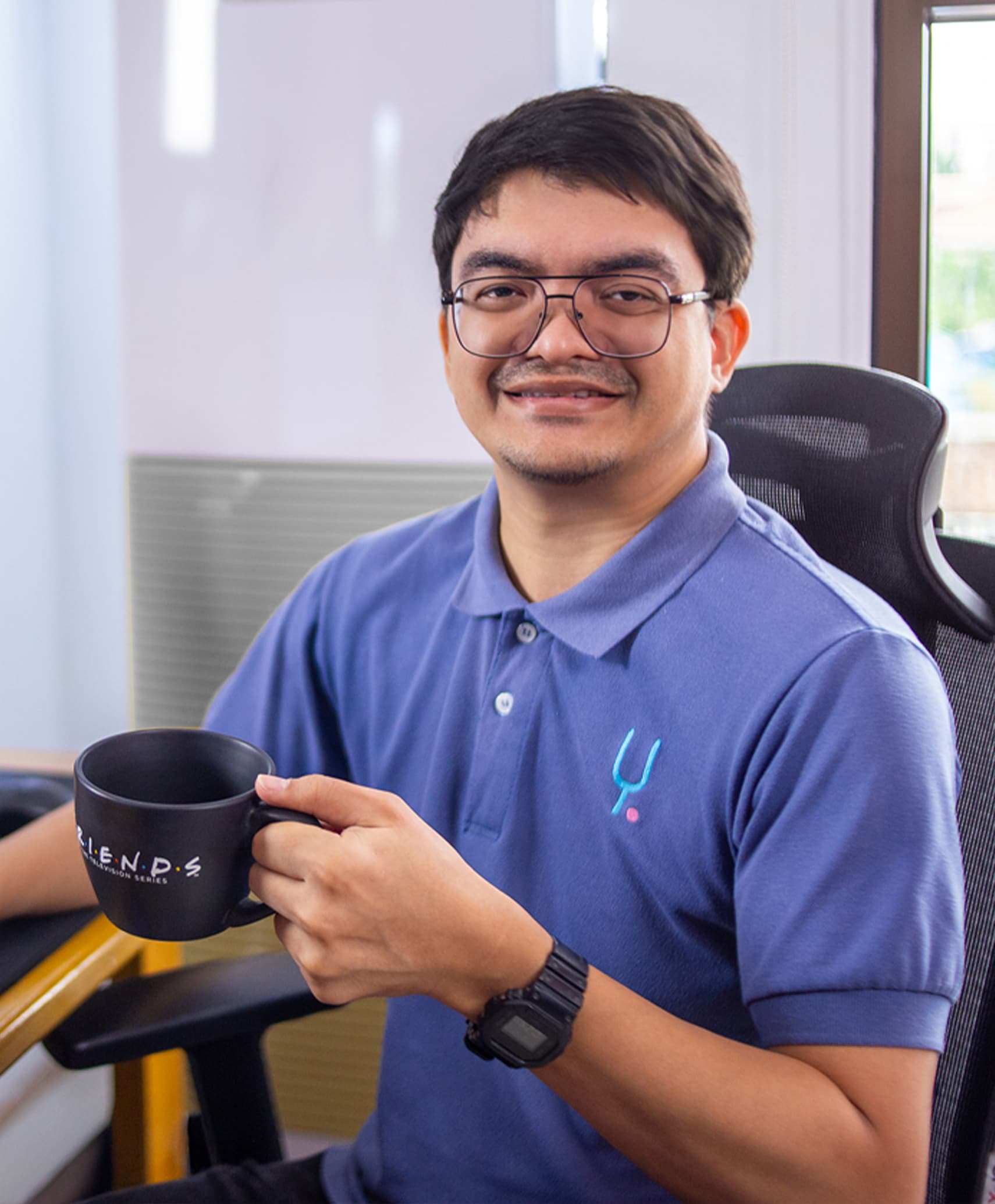 Yoonet team members collaborating over laptops in the office